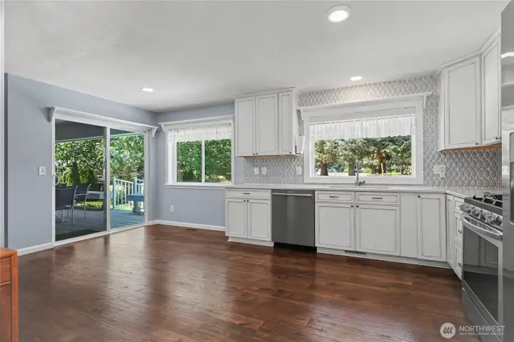 Kitchen view two from dining, HUGE space easy for helpers in your kitchen, or add an island! Large patio doors lead out to your new deck.