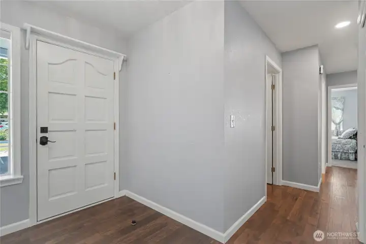Entry view, hall to your right leads to bedrooms, baths and your utility room that leads to your attached garage.