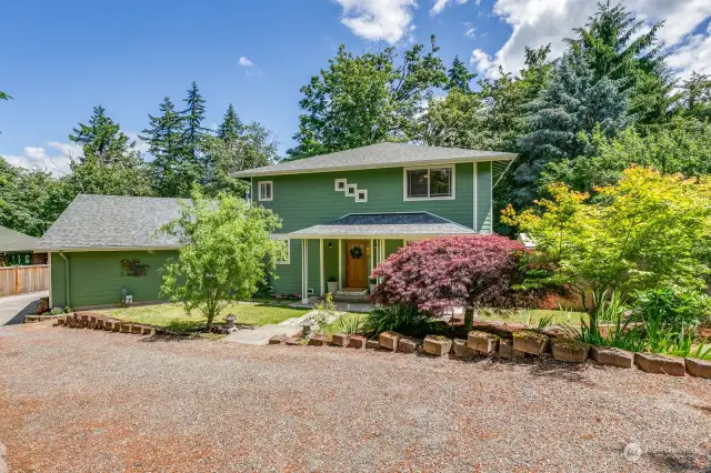 Welcome Home to this Urban Oasis on large, forested lot.
