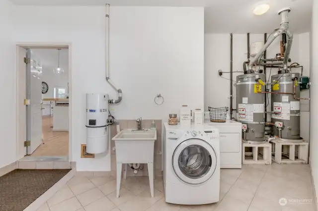 Large mud/laundry room with utility sink and plenty of space to add additional storage