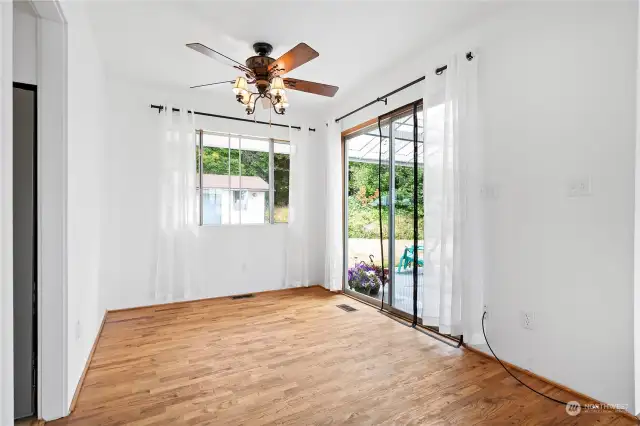 The dining room opens out to the patio.An added feature is the designer ceiling fan adding both style and improved air circulation.