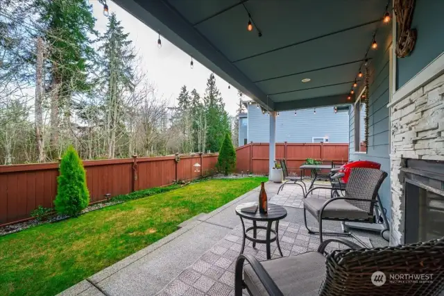 Covered back patio with a fireplace to enjoy comfort all year-round