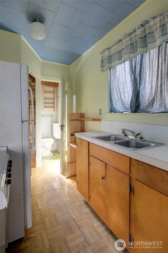 ADU galley kitchen leading to bathroom