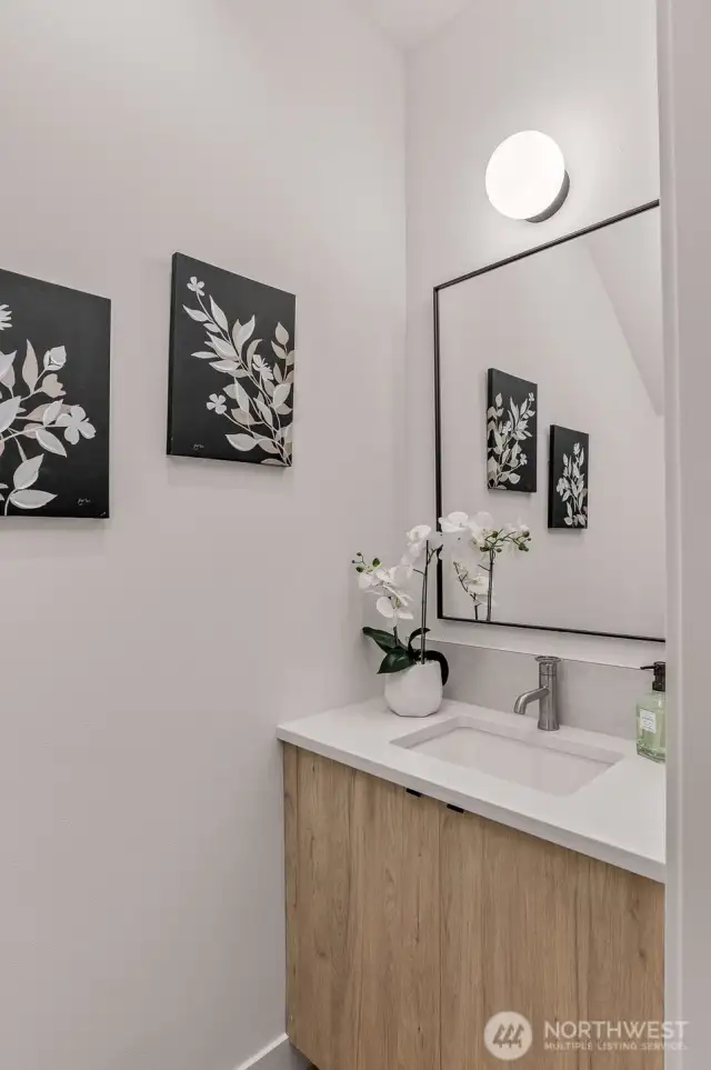 A chic and functional powder room with refined touches and modern fixtures to impress your guests.