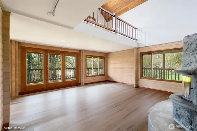 Endless potential in this sun-filled space, where expansive windows frame serene forest views. Imagine the transformation with updated floors—it’s a game changer!