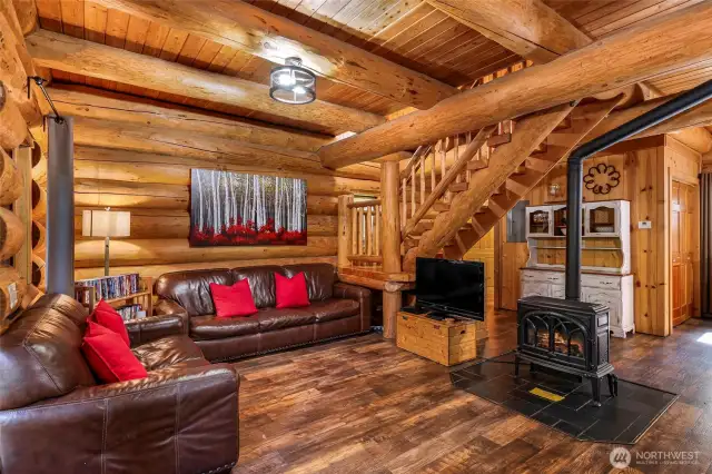 Giant wooden beams frame the great room, and the gas stove anchors the space.