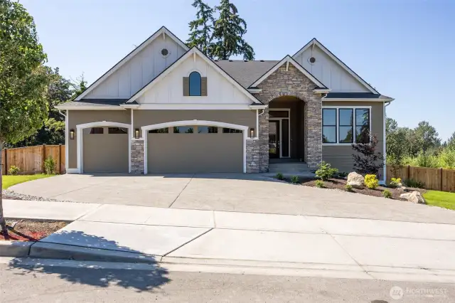 Gorgeous facade and street appeal with its 3 car garage, tasteful color scheme, and extensive stone accents.