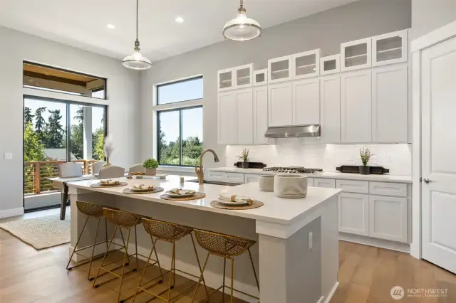 A massive central island provides a great gathering spot for casual dining or chatting with the cook.