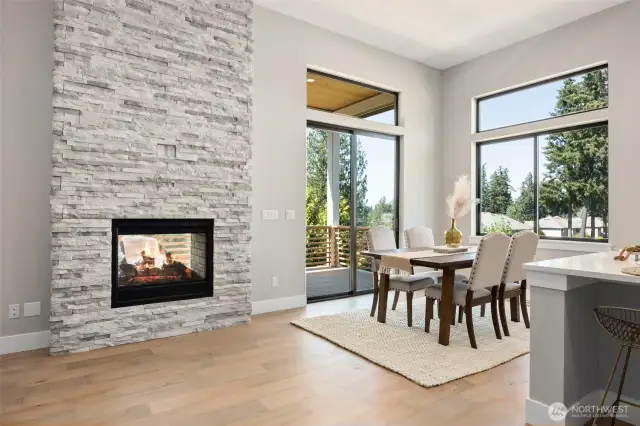 With a connected feel just off the kitchen, the gracious dining area easily accommodates large or intimate dinner parties. The nearby see-thru fireplace with dramatic floor to ceiling stone, adds ambience and character.