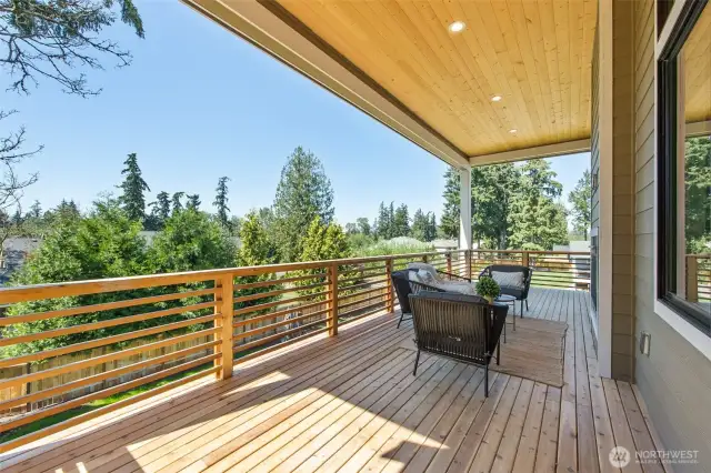 The expansive upper deck is accessible from both the main living area and the primary bedroom suite. Overlooking the property, this is a beautiful space for relaxing, dining, or entertaining.
