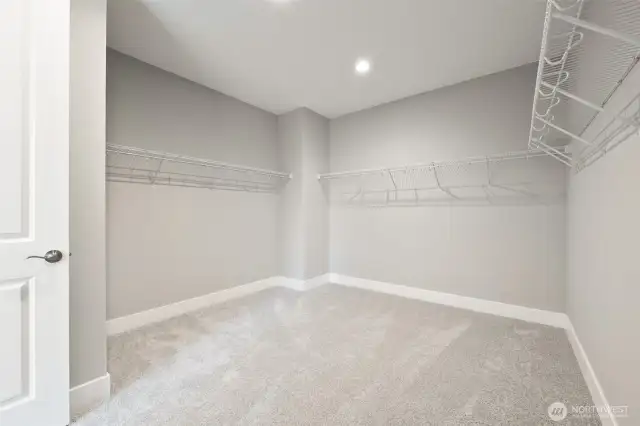 A walk-in closet large enough for a fashionistas extensive wardrobe.