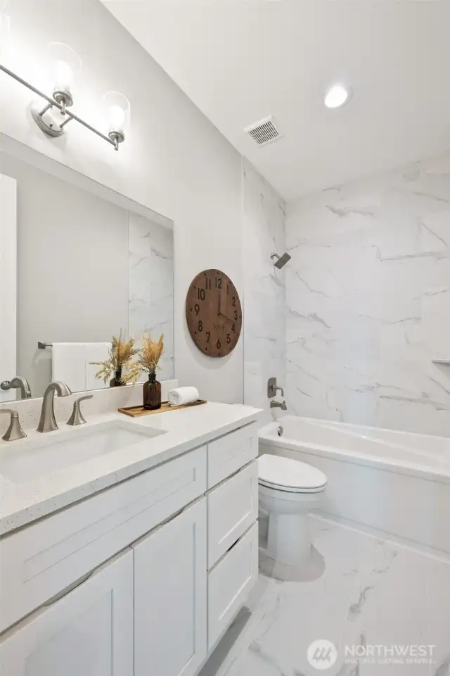 An extra, and elegant, full bathroom on the main level provides flexibility of room use. Conveniently located just across the hall from the den/office.