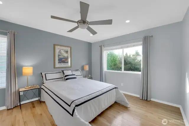 Spacious primary bedroom with ceiling fan & added canned lighting.