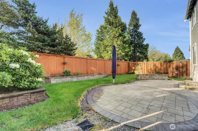 Gorgeous patio, built up garden beds, lighting around fence for extra ambiance