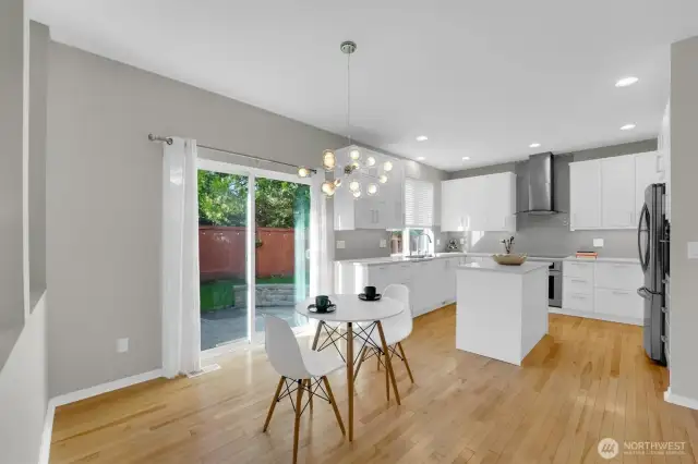 Beautifully remodeled kitchen with new white cabinets, full height glass backsplash, stainless steel appliances, nice range hood, new fixtures & more!