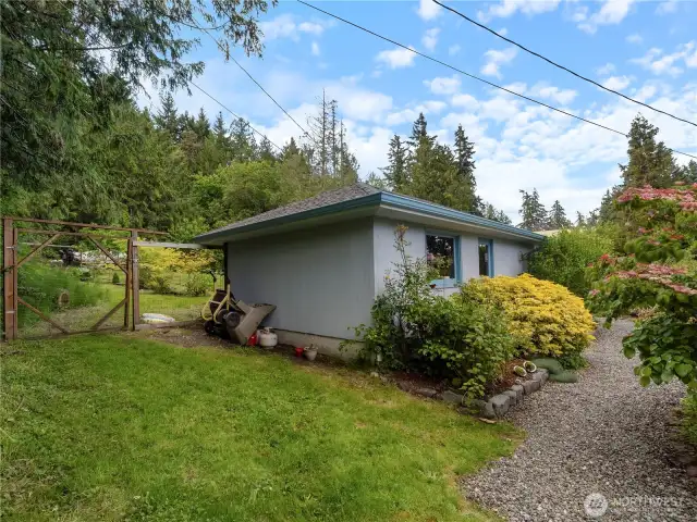 Detached garage (1 car) sits between the house and garden space.