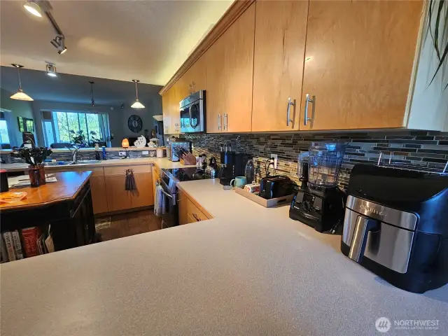 Tons of counter space wrap all around this tasteful kitchen.