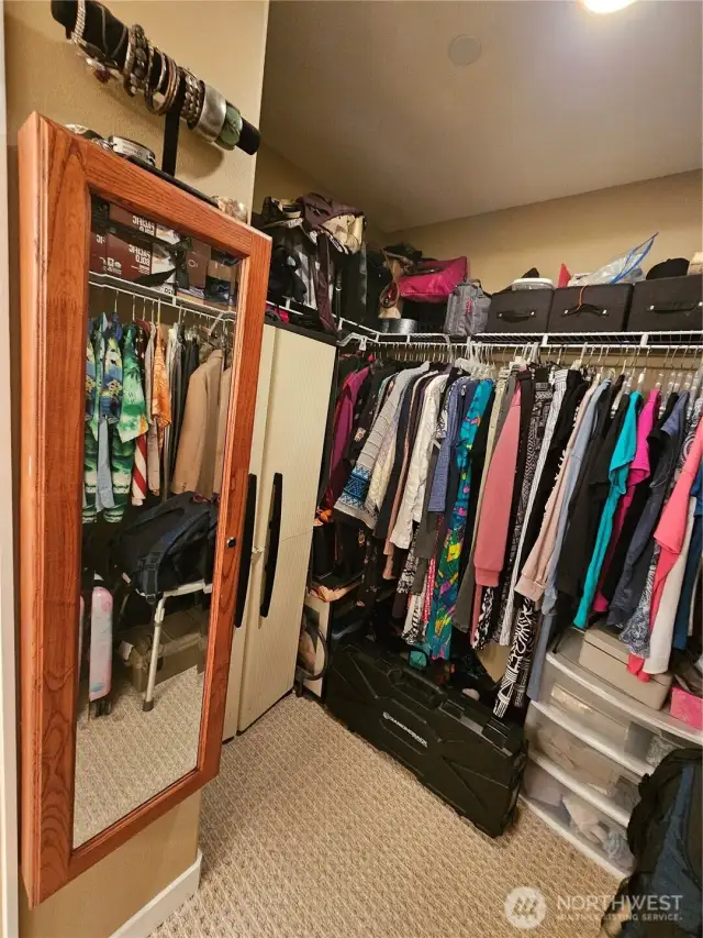 Walk in closet with ample storage in main bedroom.