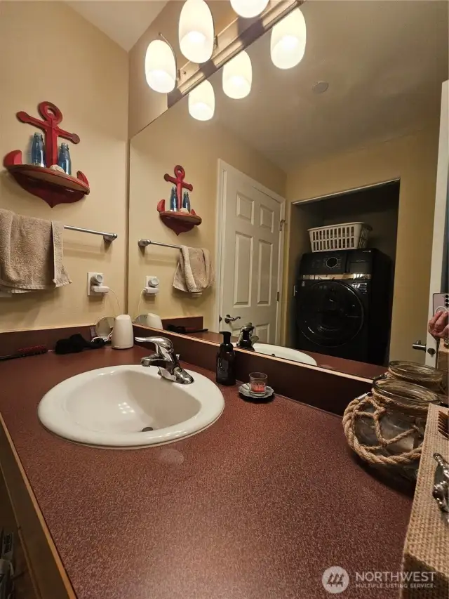 Guest bathroom off the hallway, laundry room also tucked away here.