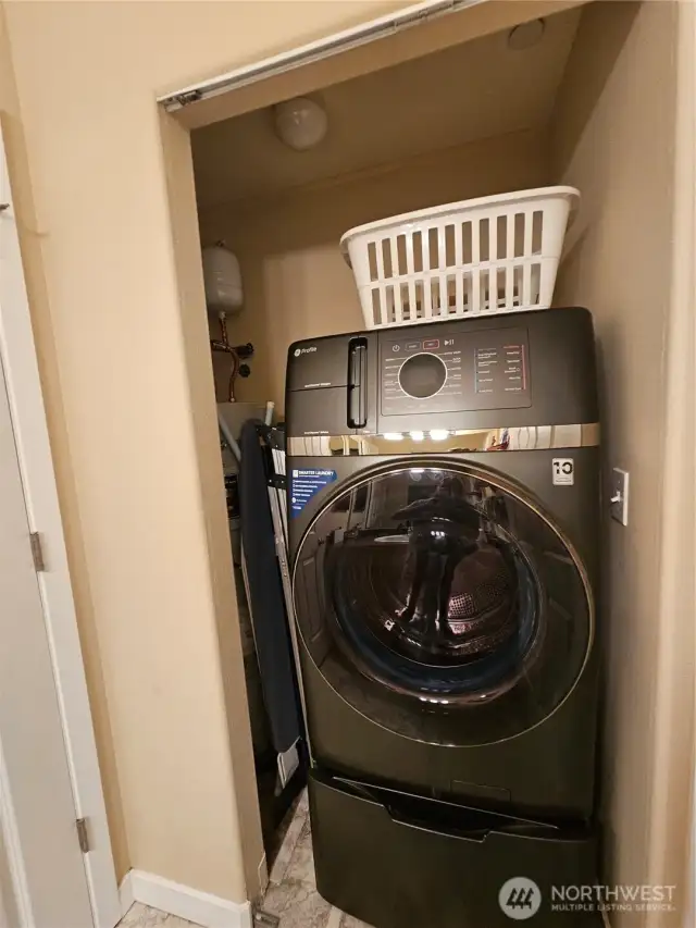 Guest bath with laundry room, toilet and shower behind separate door.