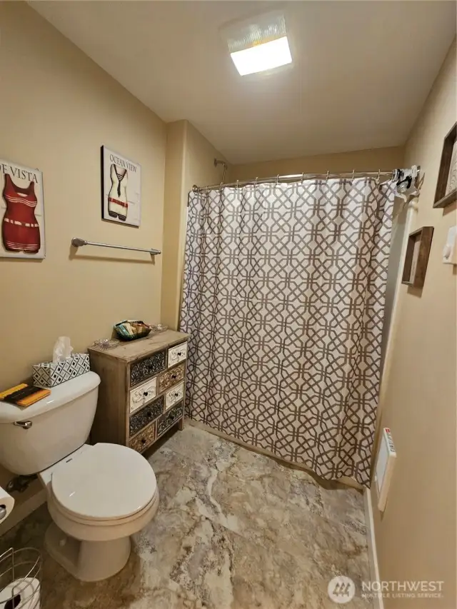 Full guest bathroom with separate shower and laundry room.
