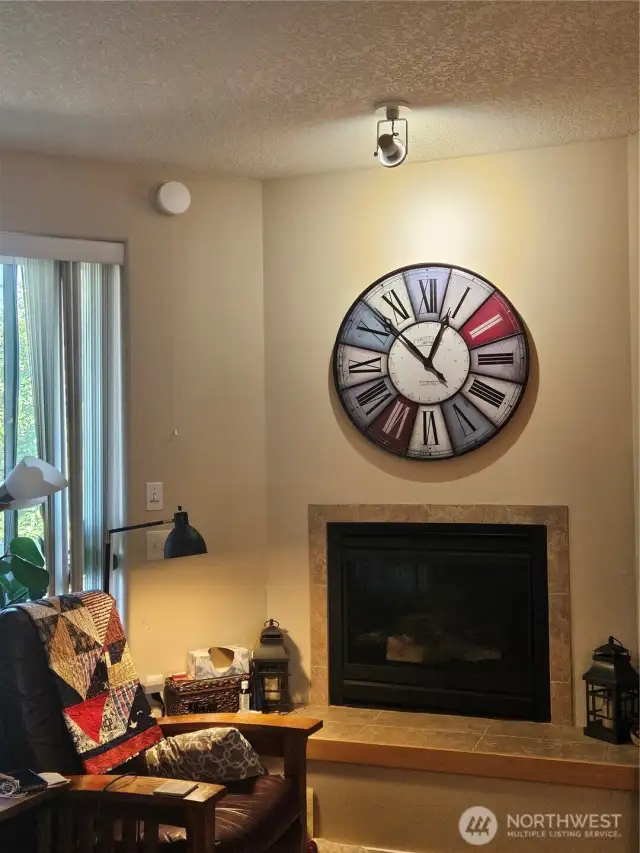 Tiled propane fireplace makes for a cozy reading spot.