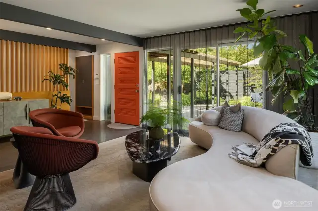 It's all about the details...sheer drapes obscure from outside, while granting a virtually-unfettered outlook from within.  A bench & additional storage tucked behind the slatted white oak entry wall.