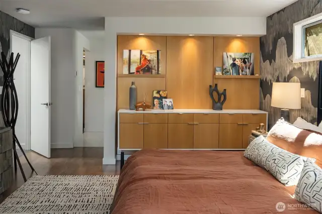 A partial wall of built-ins separates the primary bedroom from the bath (to the right) and walk-in closet (to the left.)