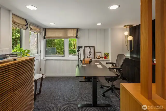 Two large windows offer natural light and a lovely outlook toward the lower yard.  The door opens to the back driveway and lower yard.