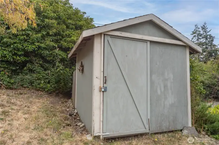 Locked storage shed. Garbage and recycling stored nearby.