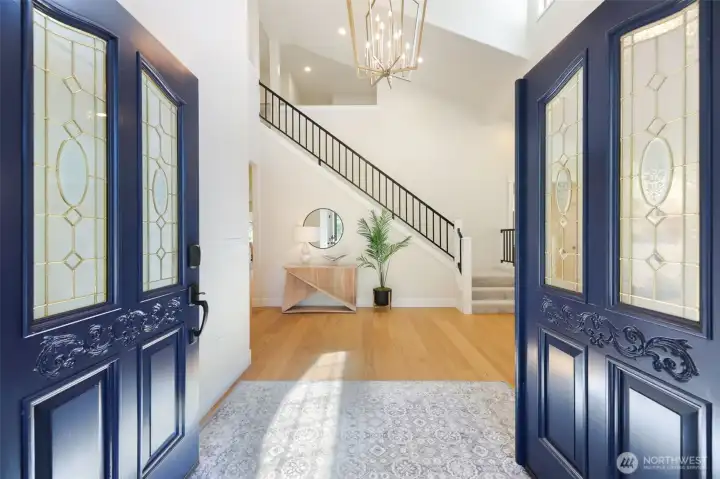 As you step through the French Door entry, the 2-story ceiling, custom railing and lighting immediately bring a sense of home!