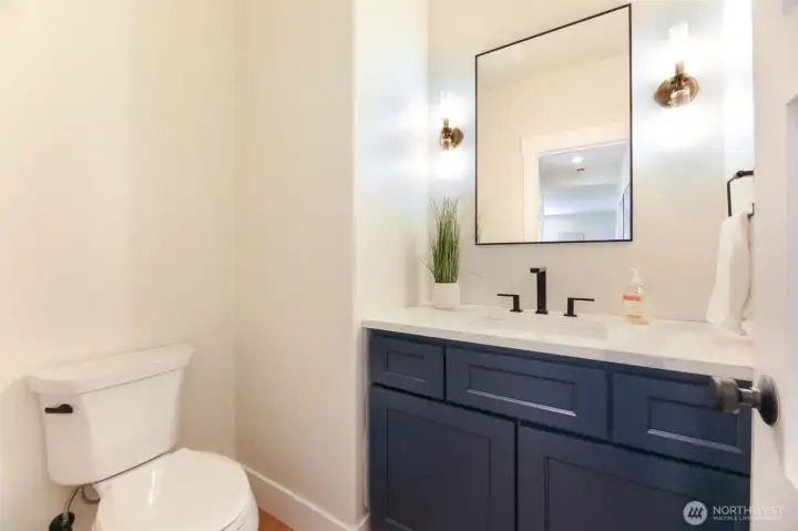 Main level powder bath, completely remodeled. This restroom is placed away from the living space for private use. (Who wants to use a bathroom next to a kitchen/living room?! Not here!)
