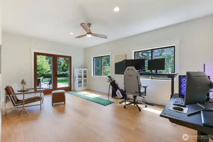 Main-Level Bonus Room / Executive Office:  Massive space ideal for an executive home office, media room.  French doors open to the deck and backyard for indoor-outdoor flow  Ideal conversion to a main-level Primary Suite including space for full bath & walk-in closet