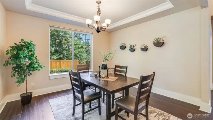 Formal dining features tray ceilings and plenty of space for dining at home or hosting your next gathering.