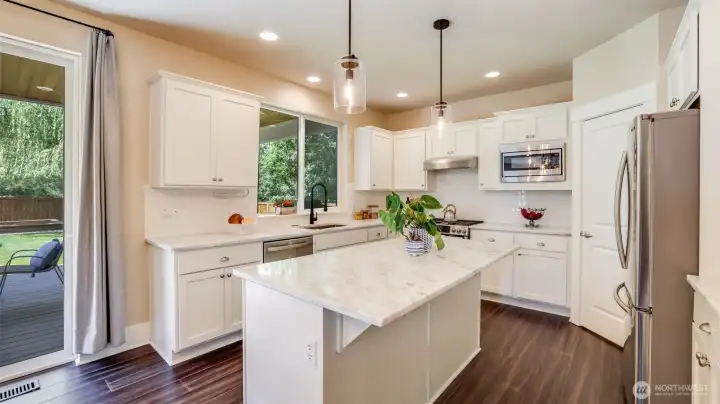 This kitchen really shines with all white cabinetry, stunning countertops, engineered hardwood floors and all stainless steel appliances.