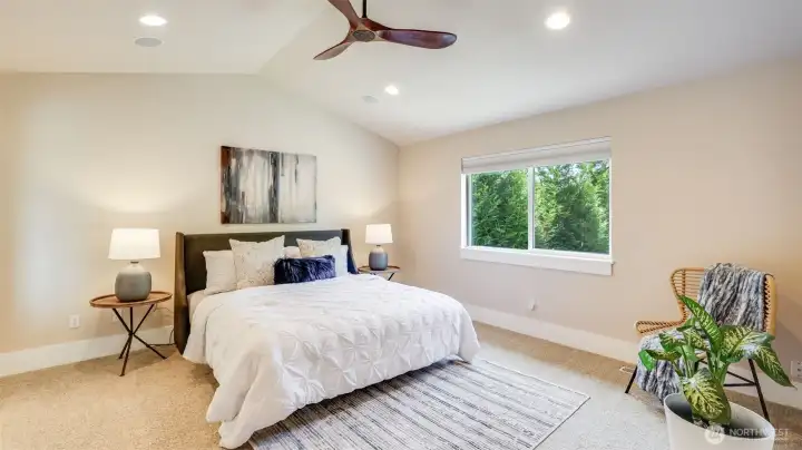 Upstairs boasts a massive primary suite with cathedral ceilings and tons of light.