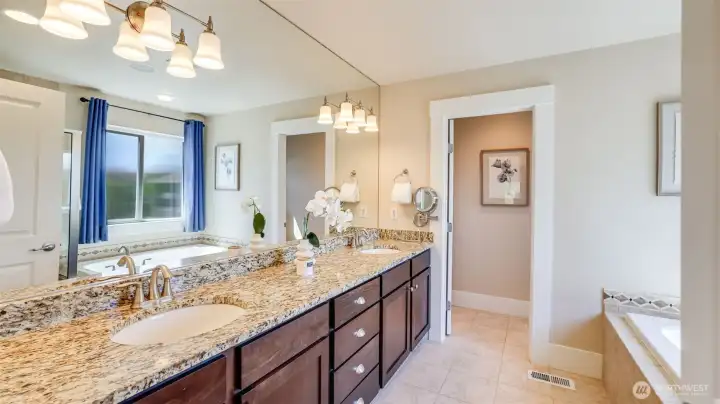 Primary en suite features granite counters, double sink vanity, large soaker tub and a separate water closet.