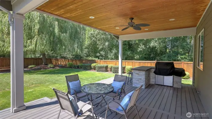 Step outside to this entertainment sized covered patio for year round enjoyment featuring a built-in gas BBQ and ceiling fan.