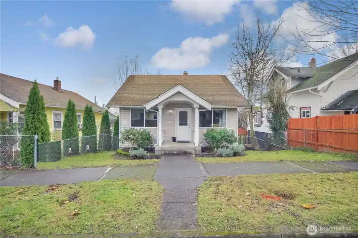 This home has mature landscape and a covered porch.  Front door has been freshly painted.