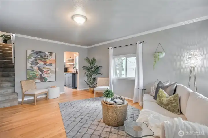 This living room has classic crown molding highlighted by real hardwood flooring.