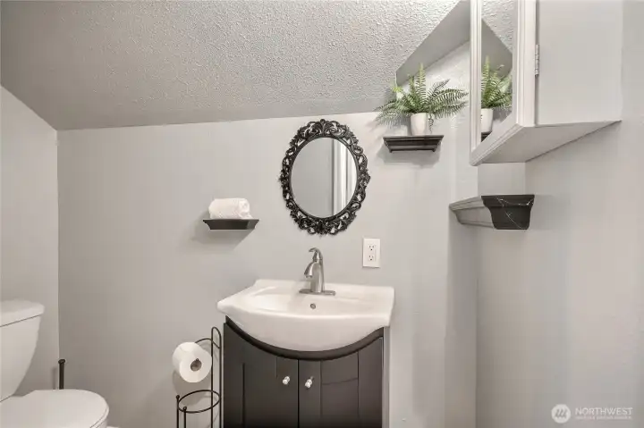 Privacy and functionality in the primary bathroom, featuring a separate area for the sink and commode.
