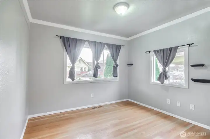 One of the two bedrooms downstairs features hardwood floors,crown molding and freshly painted.