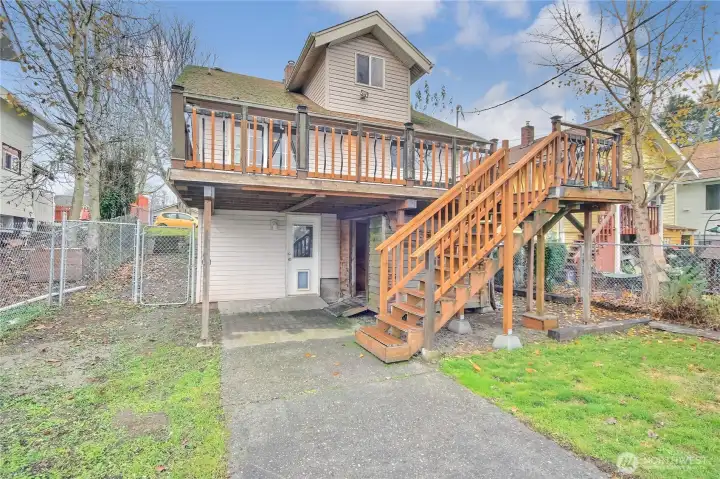 Easy access to the fenced backyard via stairs from the spacious Trex deck perfect for entertaining and outdoor living.