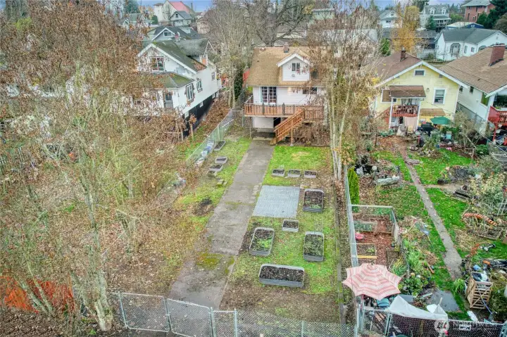 Fully fenced backyard with raised planting beds a space to grow your own garden or create outdoor living areas.