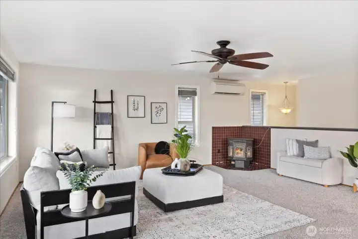 Living room with ceiling fan, mini-split and pellet stove.