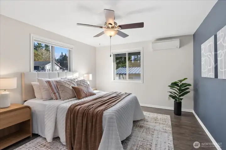 Primary bedroom with ceiling fan, mini-split & walk-in closet.