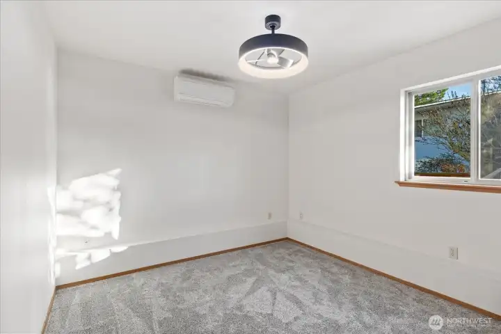 Downstairs bedroom #3 with new carpet, mini-split and ceiling fan.