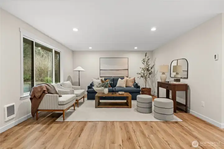 Designed for gatherings, this expansive living room seamlessly blends style with comfort while providing ample natural lighting.