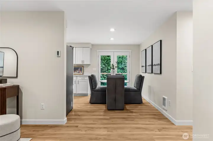 The dining area flows naturally into the gourmet kitchen, bathed in natural light and anchored by outdoor deck escape, making the heart of the home feel even more expansive.