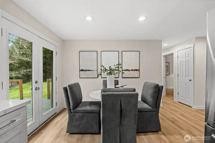 Designed for effortless entertaining, this dining area flows seamlessly through elegant French doors onto a spacious back deck.